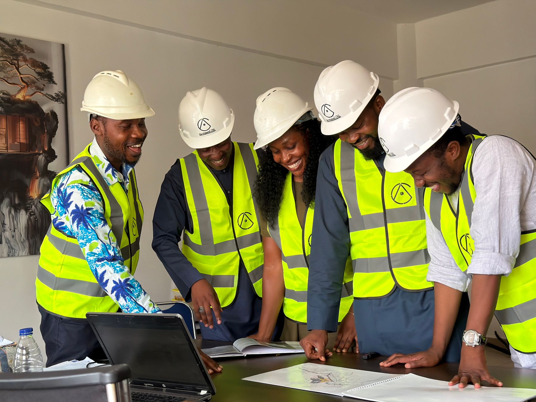 African engineers reviewing plans and sharing technical expertise