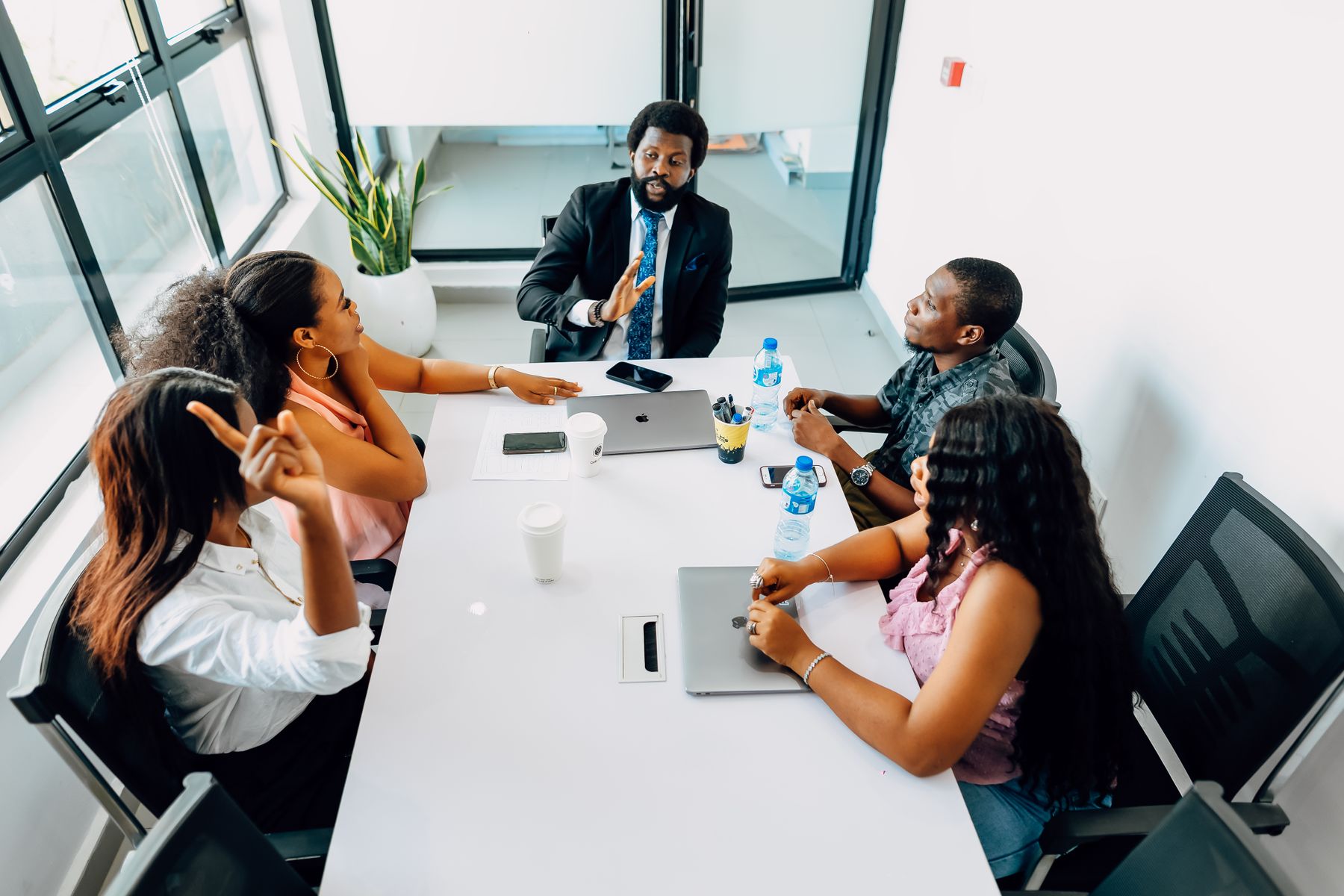 Business team discussing opportunities around a table in Lagos